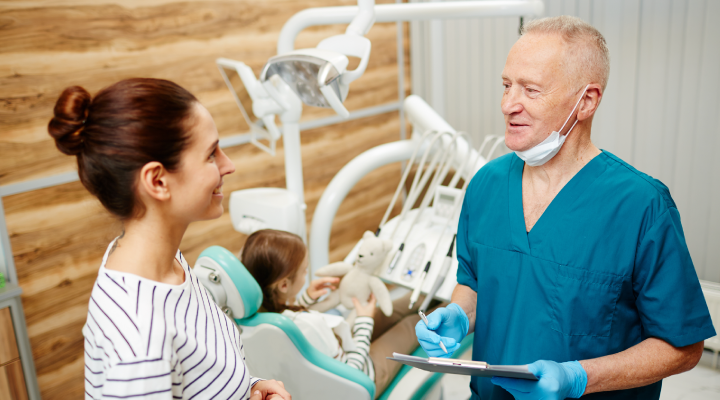 Patient and orthodontist discussing a procedure.